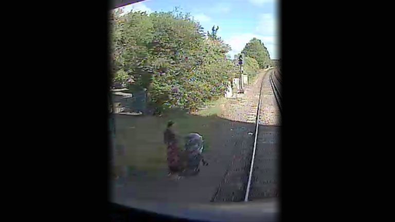 Horrifying image of woman attempting to cross live railway with a pushchair